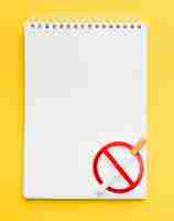 Free photo notebook with stop smoking sign