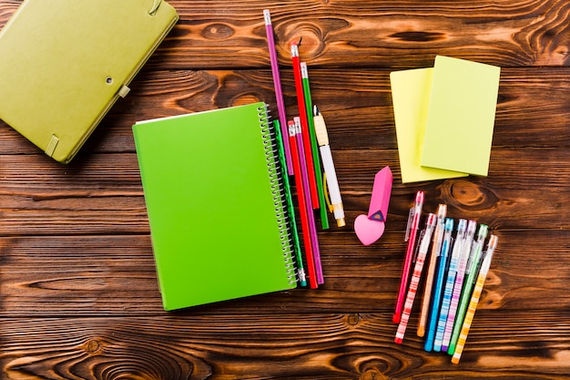 Notebooks lying near writing tools