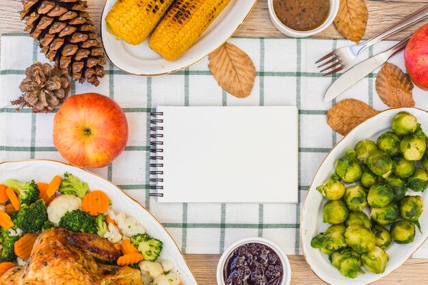 Notepad on festive table with food 