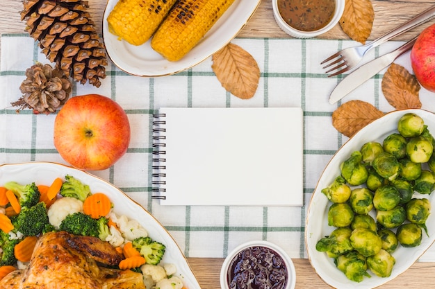 Notepad on festive table with food 