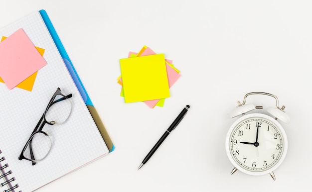 Free photo notepad glasses pen and paper reminders on a white background