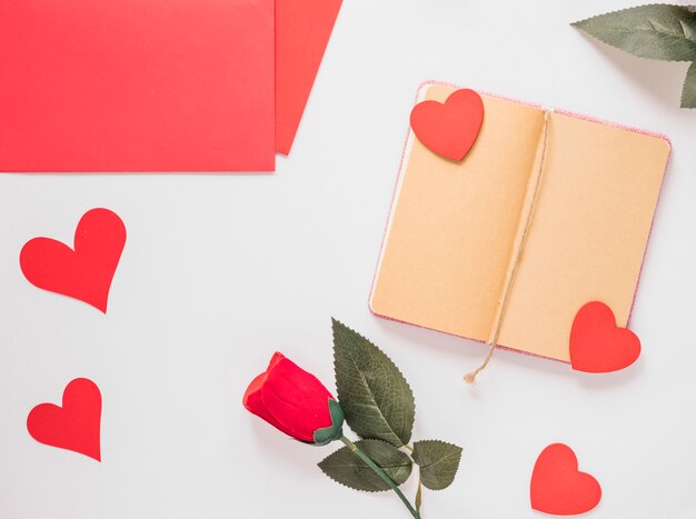 Notepad near paper, ornament hearts and flower 