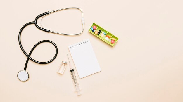 Notepad near stethoscope and medications