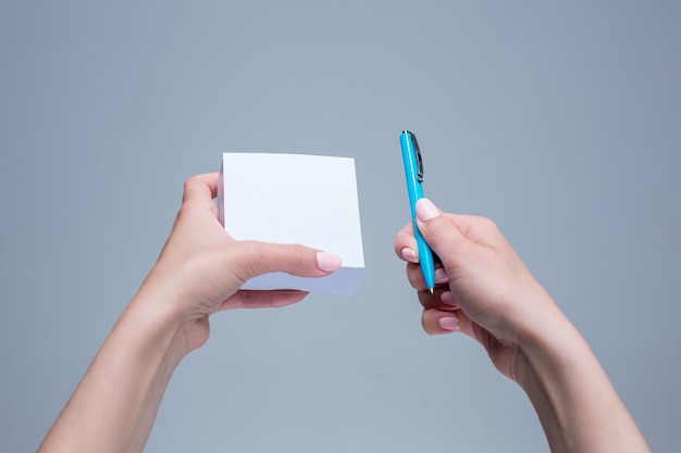 The notepad and pen in female hands