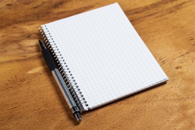 Notepad on the table with a pen