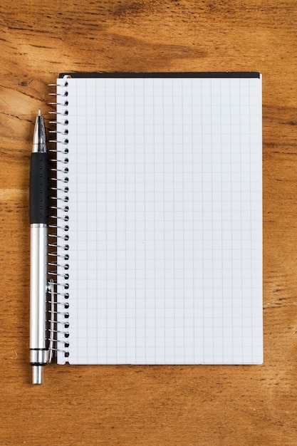 Notepad on the table with a pen