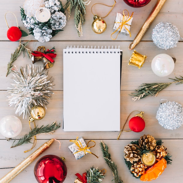 Notepad with baubles on table