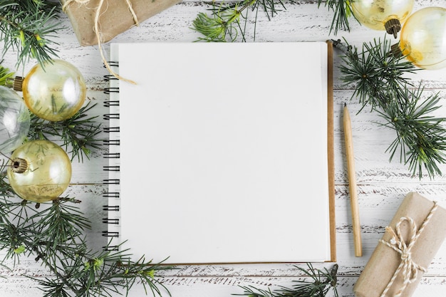 Notepad with baubles on table 