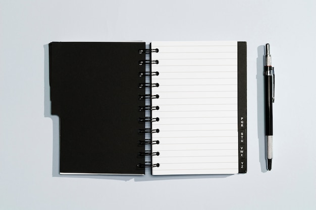 Notepad with black covers and pen