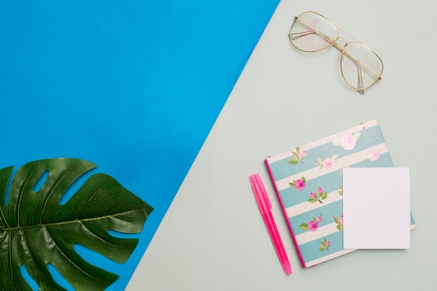 Notepad with glasses and leaf 