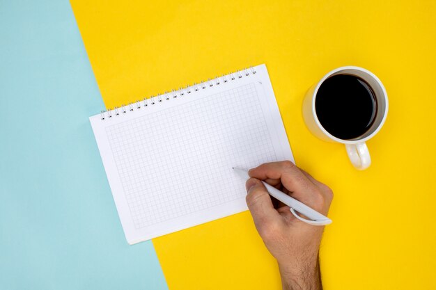 Notepad with pen keyboard and cup of coffee