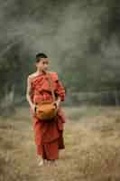 Free photo novice monks walking in the meadow