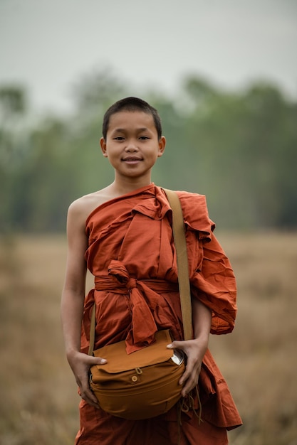 Free photo novice monks walking in the meadow