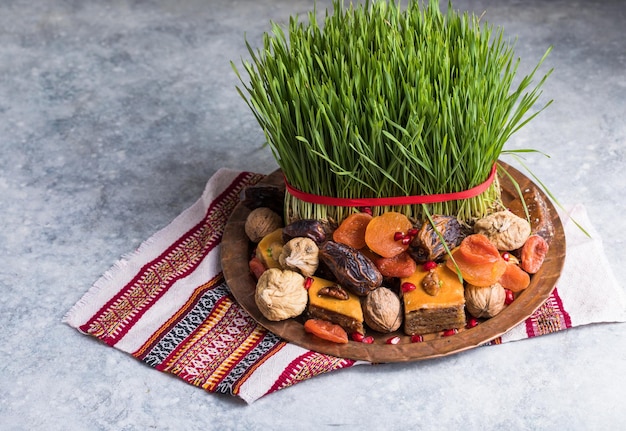 Novruz setting table decoration,  wheat grass, azerbaijan national pastry pakhlava, new year sring celebration, nature awakening