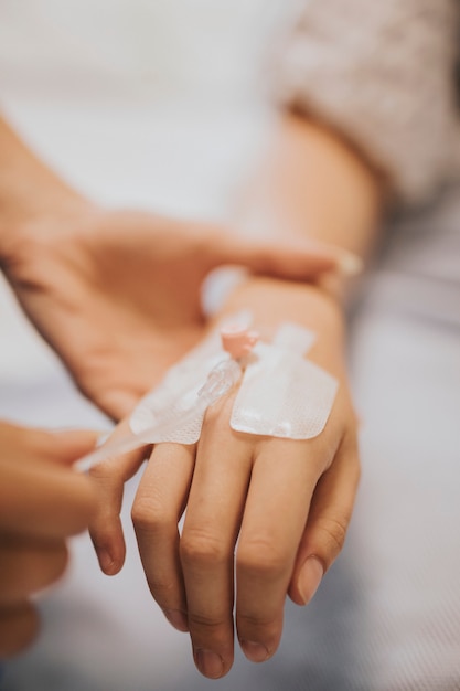 Nurse applying an IV drip to a patient