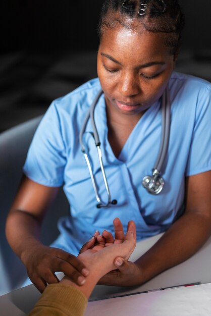 Nurse feeling the pulse high angle