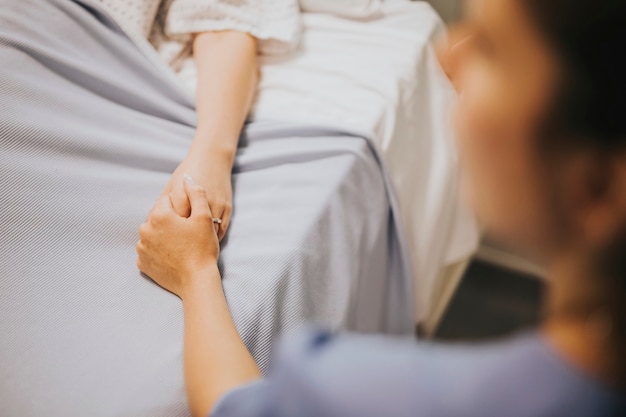 Free photo nurse holding her patients hand