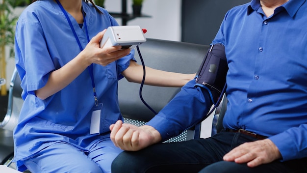 A nurse is taking a blood pressure of a patient.