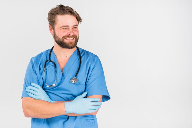 Nurse man crossing hands and looking away 