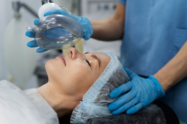 Nurse putting oxygen mask to patient