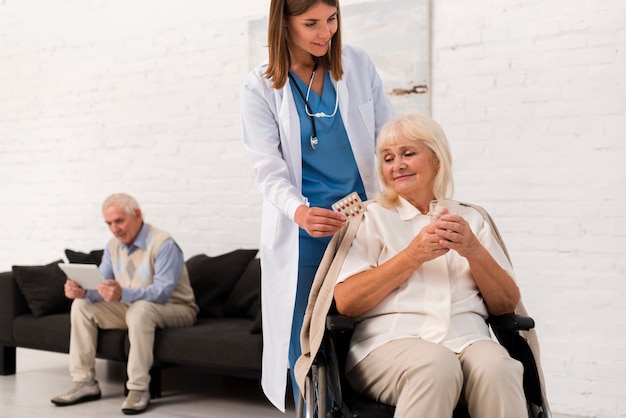 Free photo nurse taking care of old woman