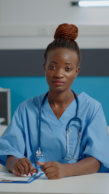 Nurse talking on video call conference with patient giving professional advice for healing treatment. Medical assistant using internet for telemedicine communication in doctors office