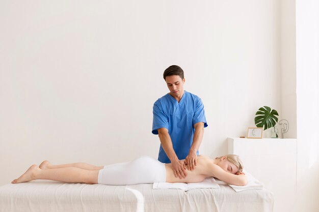 nurse with patient in osteopathy session