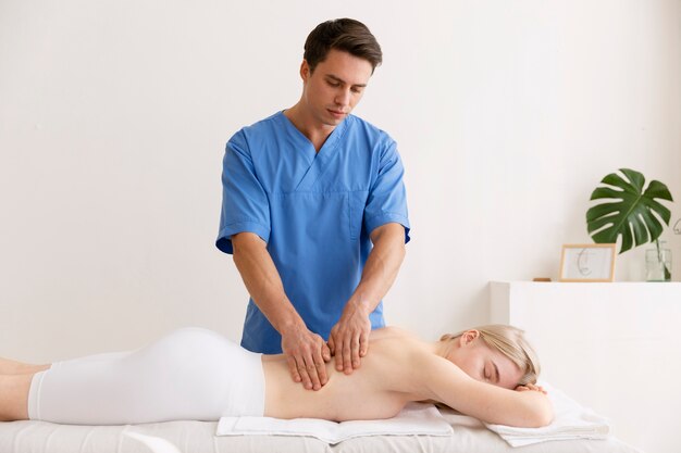 Nurse with patient in osteopathy session