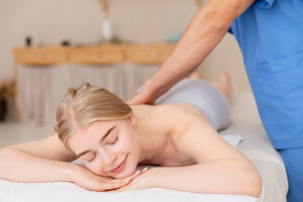 Nurse with patient in osteopathy session