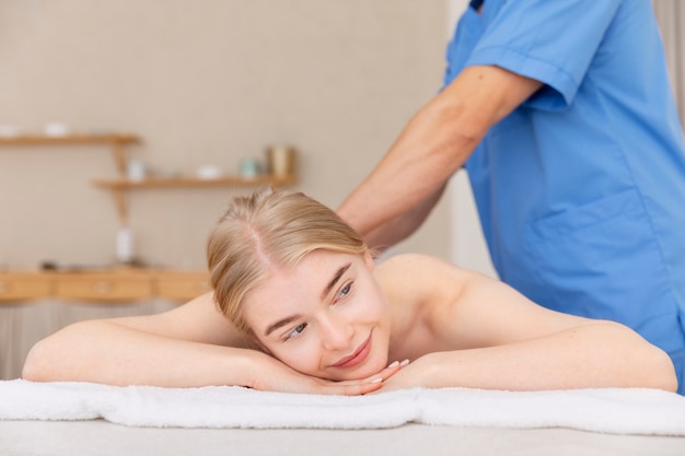 Nurse with patient in osteopathy session