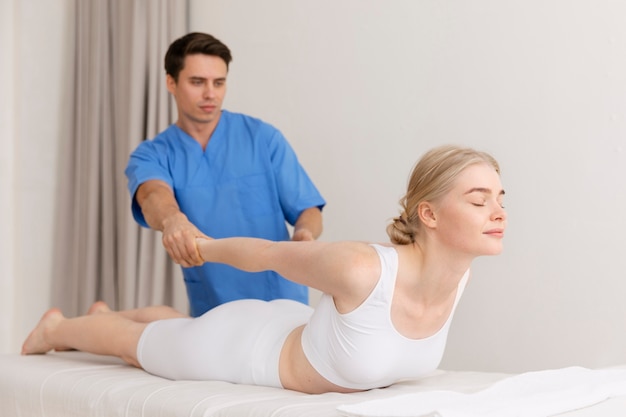 Nurse with patient in osteopathy session