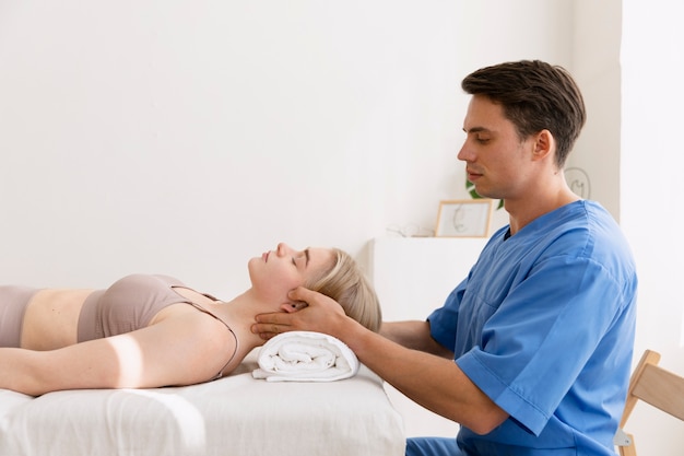 Nurse with patient in osteopathy session