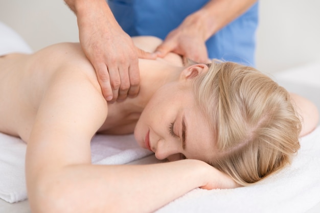 Nurse with patient in osteopathy session