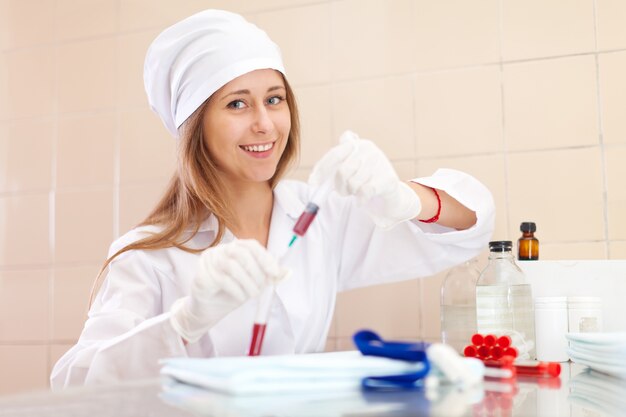 nurse works with blood sample