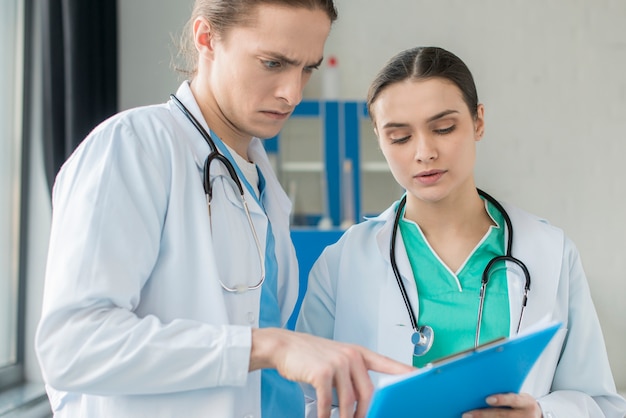 Nurses consulting clipboard