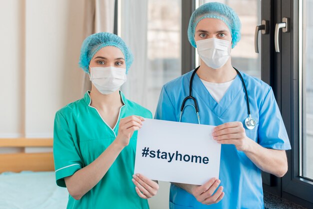nurses with stay home message