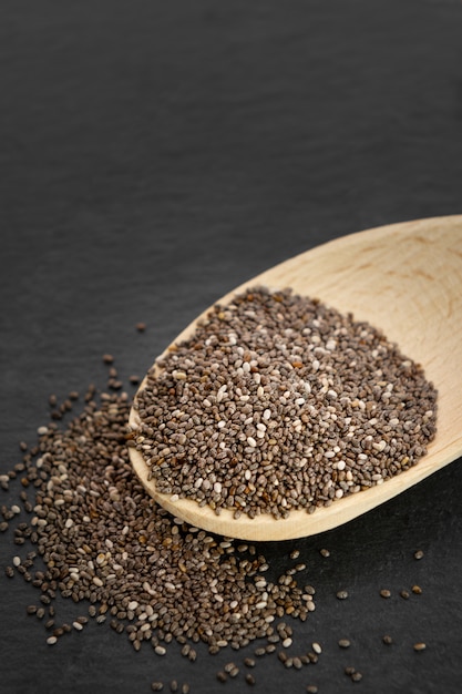 Nutritious chia seeds on a spoon, close up.