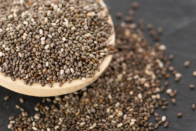 Nutritious chia seeds on a spoon, close up.