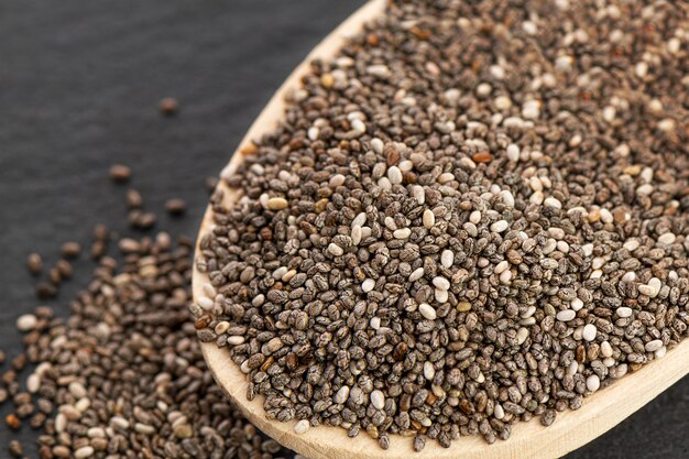 Nutritious chia seeds on a spoon, close up.