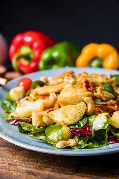 Nuts; chicken and summer vegetables on a plate over table