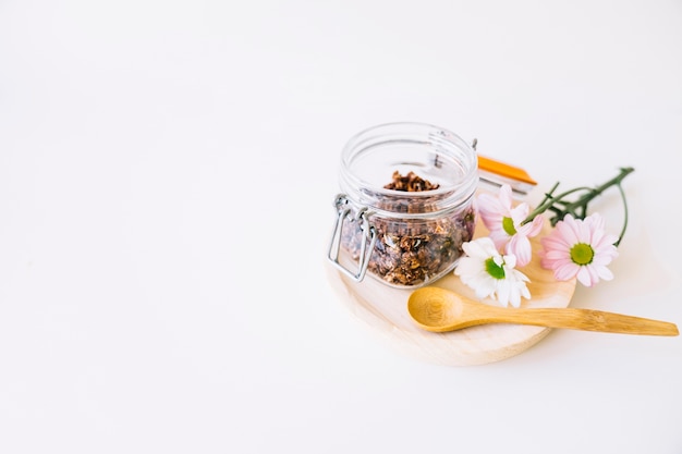 Nuts in glass on wooden plate with space on left