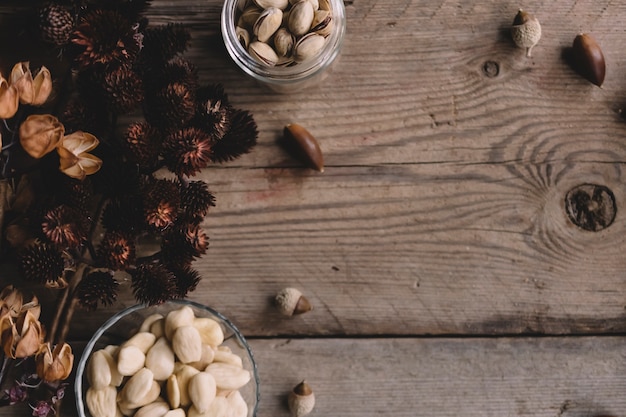 Nuts in glasses with wildflowers and space on right