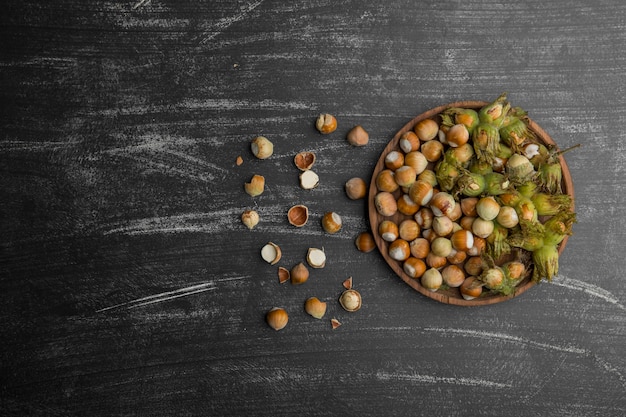 Free photo nuts in shells with green leaves