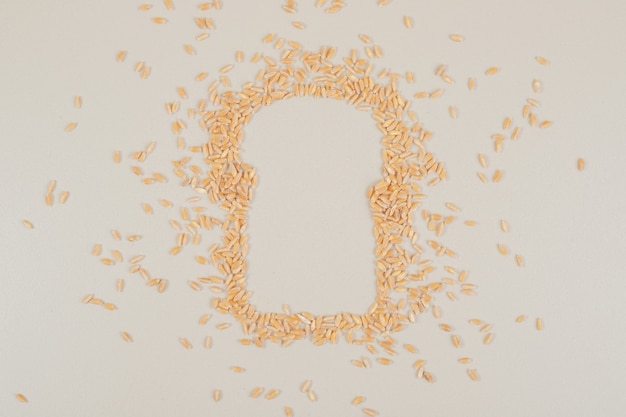 Oat grains as a bread on white surface