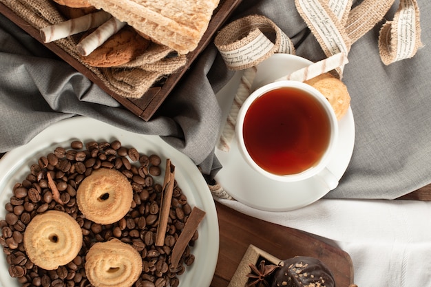 Oatmeal and chocolate cookies with a cup of tea. Top view