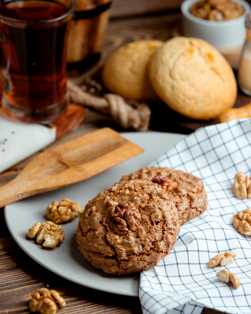 Oatmeal cookies with nuts and a cup of aromatic tea