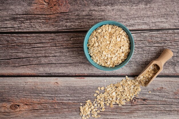 Oatmeal grains in a plastic bowl on the table