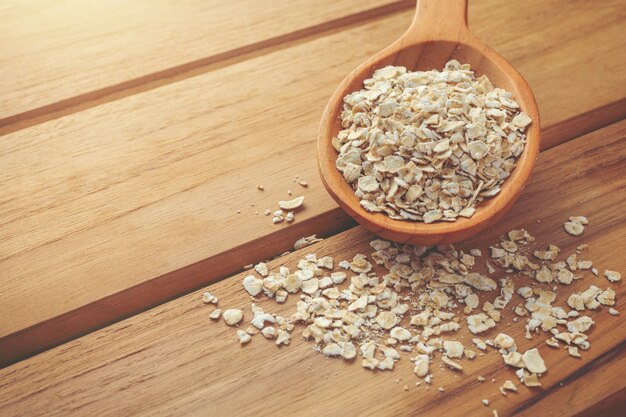 Oatmeal is placed on a brown wood .