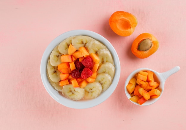 Oatmeal with apricot, banana, berries in a bowl