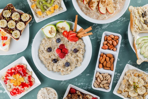 oatmeal with fruits, jam, sandwich, cinnamon, nuts, oat flakes in plates